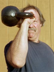 John Brookfield performing a kettlebell hold