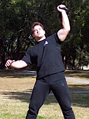 Ken James snatching a 32 kg bell at the first Florida Kettlebell Championship (2003). Photo via Girevik Magazine.